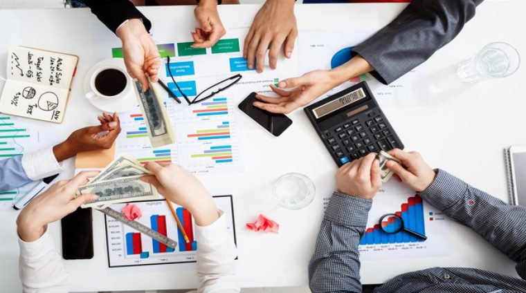 Picture of businessmen’s hands on white table with documents and drafts Picture of businessmen's hands on white table with documents, coffee and drafts